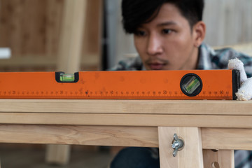 Carpenter working on wood craft at workshop to produce construction material or wooden furniture....