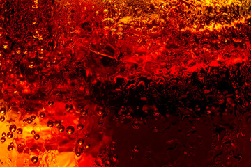 Close up view of the ice cubes in dark cola background. Texture of cooling sweet summer's drink...