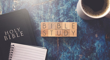 Bible Study Written in Block Letters on a Blue Wood Table with a Bible