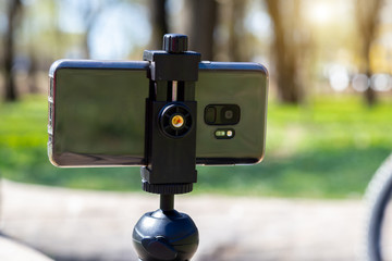 Phone on a tripod for outdoor video.