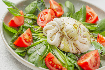 Burrata cheese. Salad with Italian burrata cheese, balsamic and cherry tomatoes.