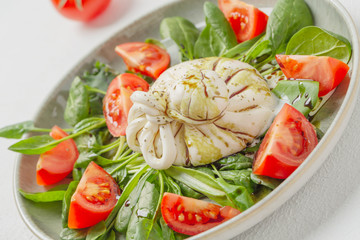 Burrata cheese. Salad with Italian burrata cheese, balsamic and cherry tomatoes.