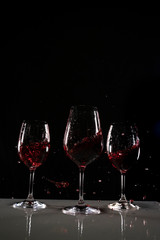 red wine in a wine glass with black background