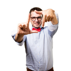 Man wearing a red bow tie. Doing a frame with his hands.