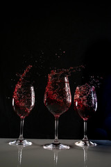 red wine in a wine glass with black background