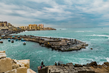 Fototapeta na wymiar Scenic Rainy Day, People Fishing in the Mediterranian sea Alexandria, Egypt