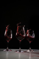 red wine in a wine glass with black background