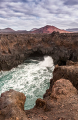Lanzarote landscape. Los Hervideros coastline, lava caves, cliffs and wavy ocean. Lanzarote island, Canary Islands, Spain