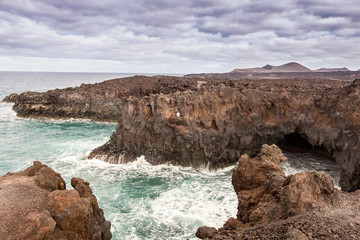 Lanzarote landscape. Los Hervideros coastline, lava caves, cliffs and wavy ocean. Lanzarote island, Canary Islands, Spain