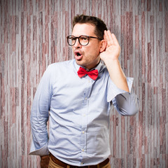 Man wearing a red bow tie. Paying attention to a noise.