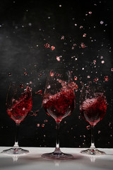 red wine in a wine glass with black background
