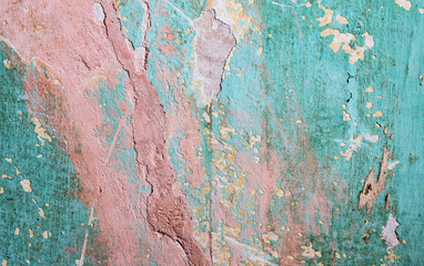 Pink and blue faded and distressed plaster wall grunge background
