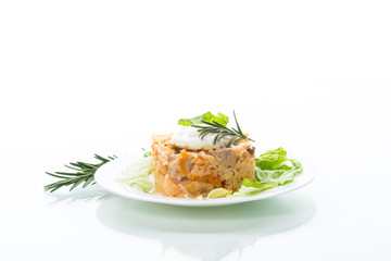 boiled rice with vegetables and fried egg with salad leaves in a plate