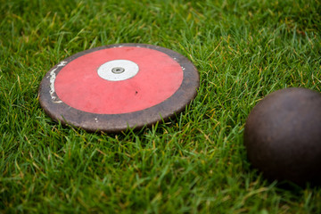 Discus and shot put on the grass, track and field equipment