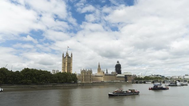 A wide shot of the UK's Parliament during a cloudy day with some sunshine.