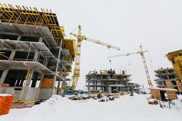 
construction site with cranes in winter