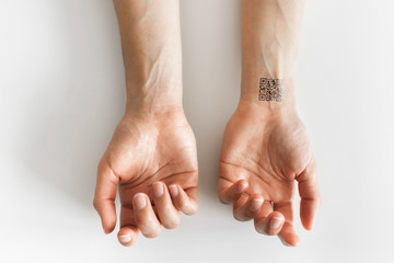 Hand with qr code on wrist. Future of political population control. Chipization of people.