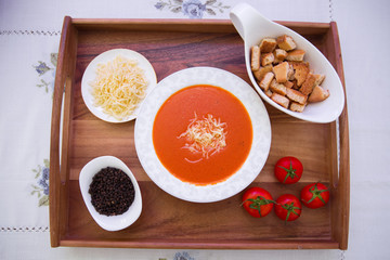 Red lentil soup . Spaghetti white plate . Dry bread and pepper . Red tomatoes . Tomato Soup wooden tray .