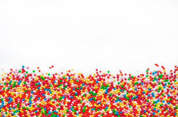 Colored sugar balls on a white background. Used to decorate baking and sweets.