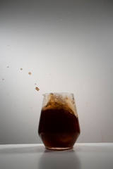 coke splash with ice in a drinking glass