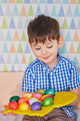 Fototapeta na wymiar Different color Easter Eggs in a child's hands- egg hunt.