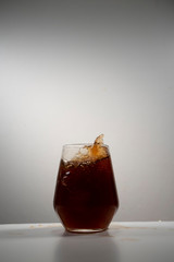coke splash with ice in a drinking glass