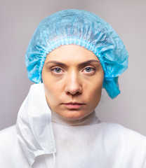 portrait of doctor woman in medical uniform looking seriously at camera