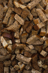 crackers are scattered on a cotton cloth for salad beer snacks with garlic and cereals from rye bread with seeds