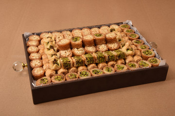 Ramadan Arabic desserts (Kunafa and Baklava) decorated in a brown gift box