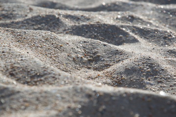 Sea sand close-up, mountains of sea sand on a sunny day, wallpaper, background.