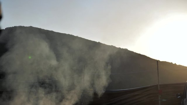 Airsoft. Evening. Smoke over a military camp in the mountains
