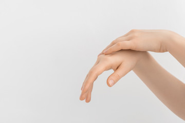 Young woman applying hand cream. Cropped shot of woman applying organic cream on hands. Beautiful woman hands with cream. Hand skin care concept.