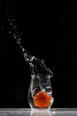 tomato water splash in a drinking glass