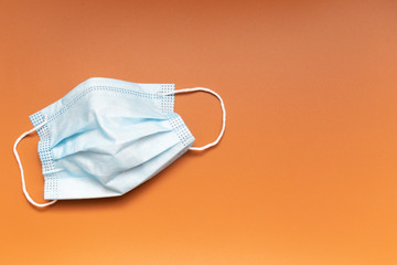 Flu mask with copy space, flat lay. Concept of prevention