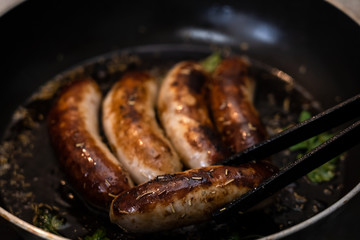hunting sausages fried in a pan with spices