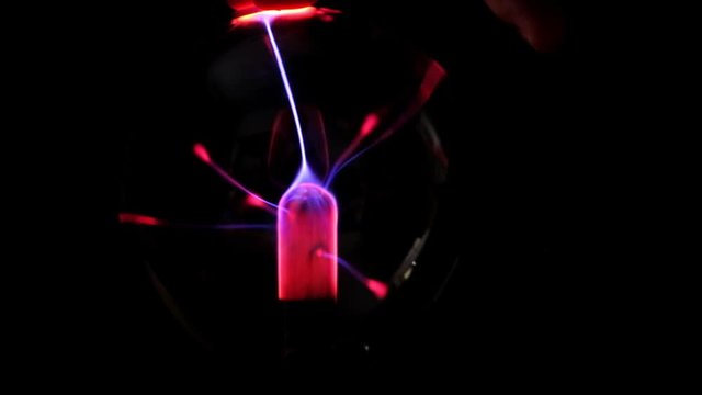 Plasma ball lamp, Tesla Coil experiment with electricity, plasma lamp close-up. Beautiful Abstract backdrop, Disco lights background. 4k video. dark.