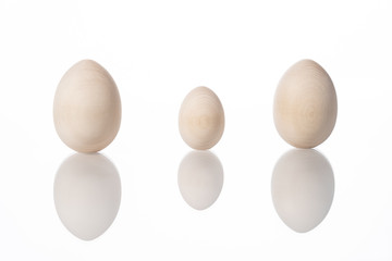 Three eggs of different sizes on a white background. Easter