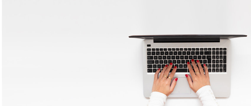 Banner of girl hands in a laptop. Business workspace with blank clean copy space, flat lay, above view