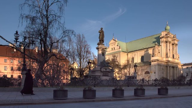 WARSAW, POLAND - MARCH 23, 20020: Monument of Polish poet Adam Mickiewicz on main touristic street Krakowskie Przedmiescie during COVID-19 epidemic time. Usually this place is filled with people.