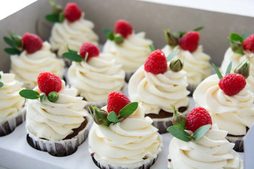cream cupcakes with raspberry