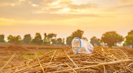Foam boxes, plastic cluttered on a haystack on the field.Plastic waste on the field is not allowed...
