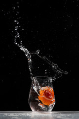 tomato water splash in a drinking glass