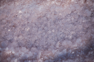 Beautiful crystals of pink salt at the bottom of a salt lake