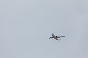 plane in sky landing overcast weather