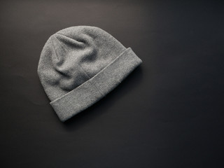 Gray worm winter woolen hat cap flat isolated on black background.