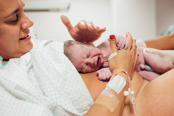 Mother who just gave birth to her son in the hospital - obrazy, fototapety, plakaty