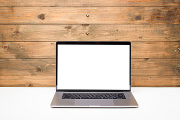  An open laptop with blank white screen on white desk against black wooden  background