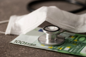 Euro banknotes and stethoscope