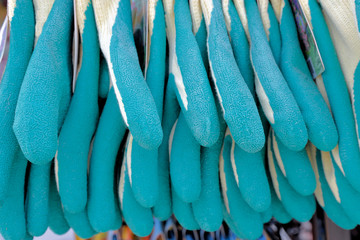 A closeup of a row of gloves for gardening.