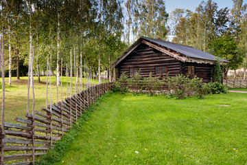 Old traditional Norwegian wooden village house with wooden fence